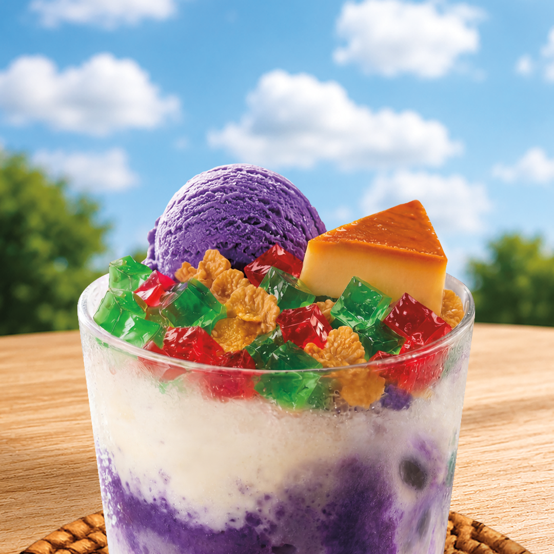 Colorful dessert with ube ice cream and corn flakes, leche flan, red and green nata de coco in a glass against a blue sky background
