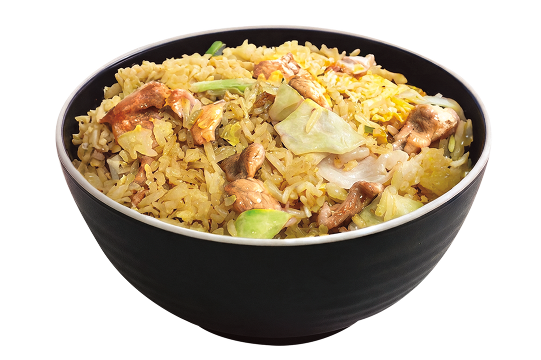 A black bowl filled with chicken chao fan fried rice mixed with egg bits and chopped cabbage against a plain black background