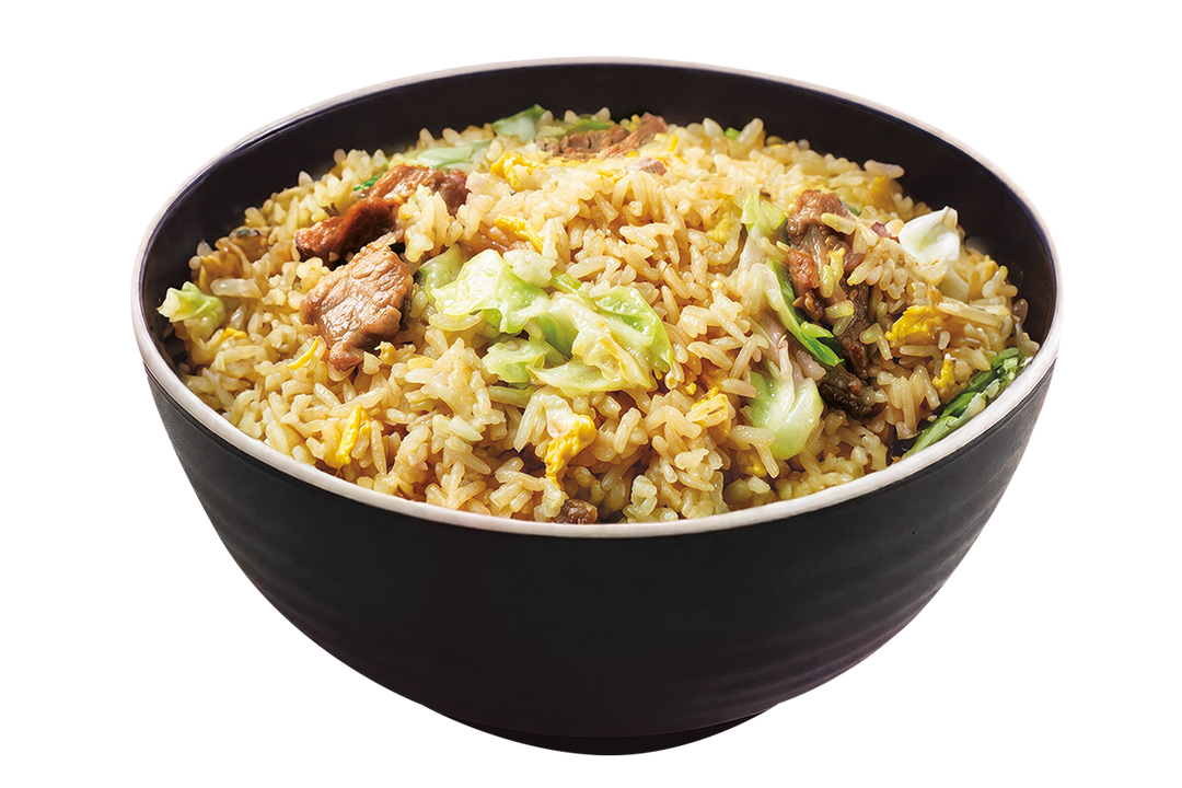 A black bowl filled with pork chao fan fried rice mixed with egg bits and chopped cabbage against a plain black background
